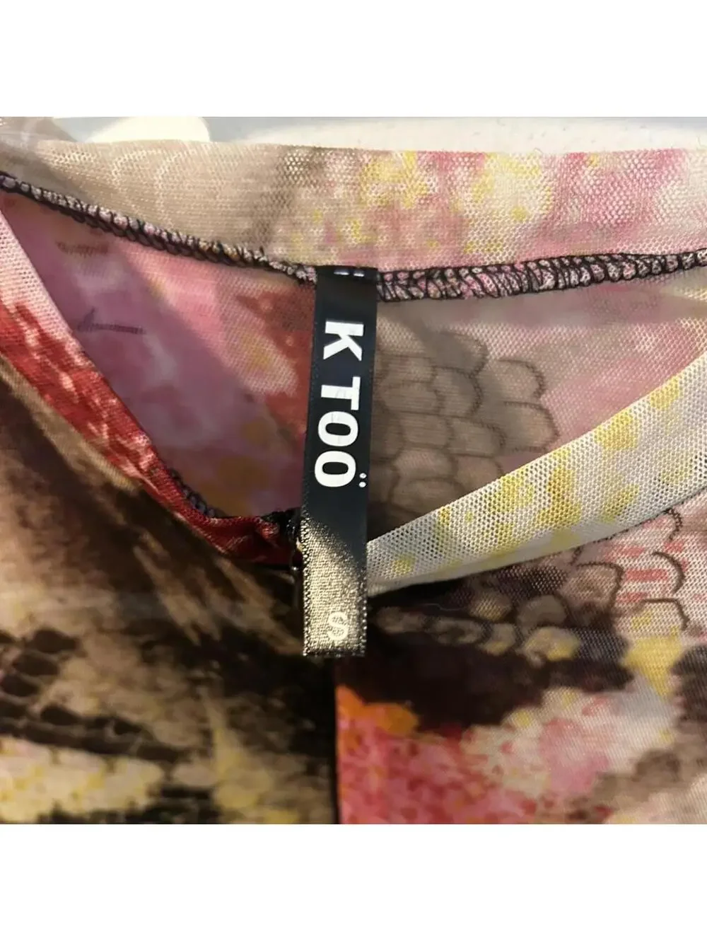 KToo multi-colored snakeskin print mesh jumpsuit with zipper and cut out hips